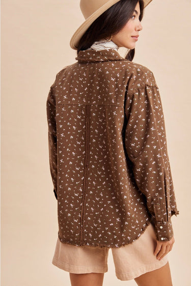 Back view of a women’s brown floral shacket showing the relaxed fit and fringed hem