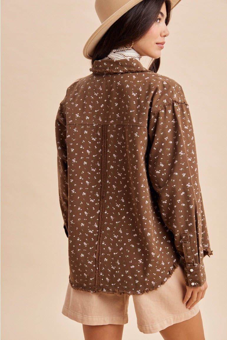 Back view of a women’s brown floral shacket showing the relaxed fit and fringed hem
