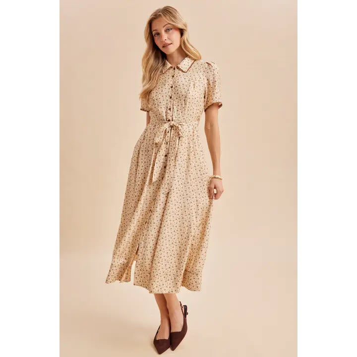 Woman wearing a buttercream floral button-down tie-waist maxi dress