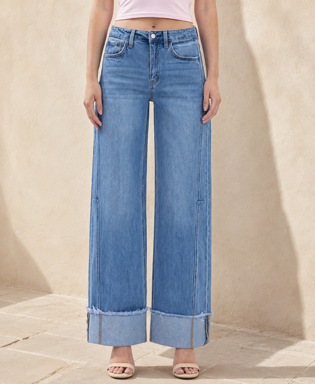 Front detail of women’s high-rise wide-leg jeans with medium wash and 4-inch cuffs